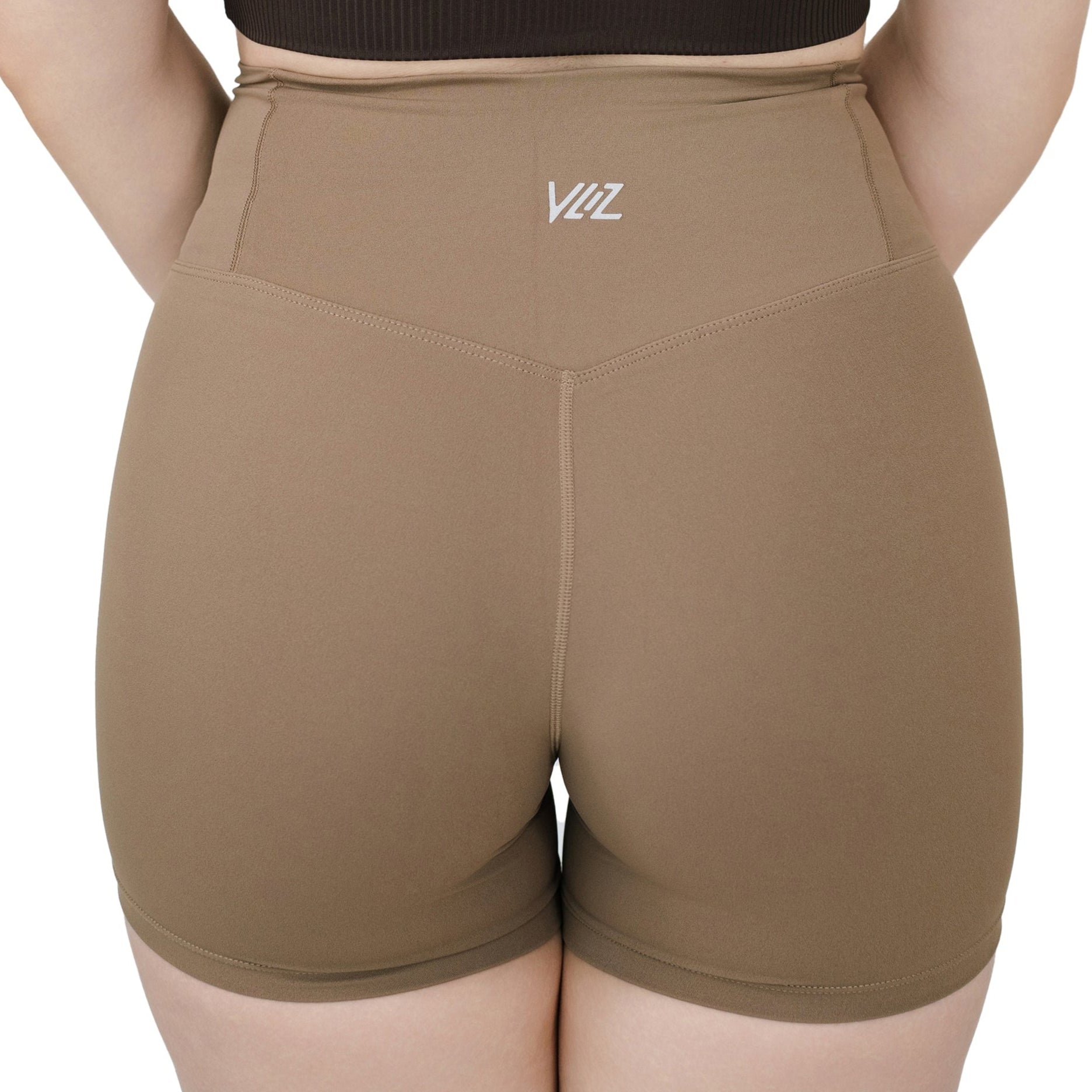 Close-up back view of VLIZ Ultra Soft SculptFit Short Leggings in Light Brown, showcasing sculpted seam lines, high waistband, and tonal logo placement.