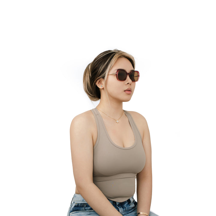 VLIZ Vista sunglasses with pink translucent square-edge frame and brown lenses, designed with a relaxed silhouette and engraved logo on temples
