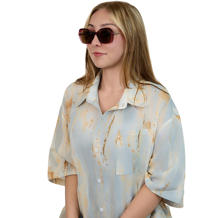 VLIZ Vista sunglasses with pink translucent square-edge frame and brown lenses, designed with a relaxed silhouette and engraved logo on temples