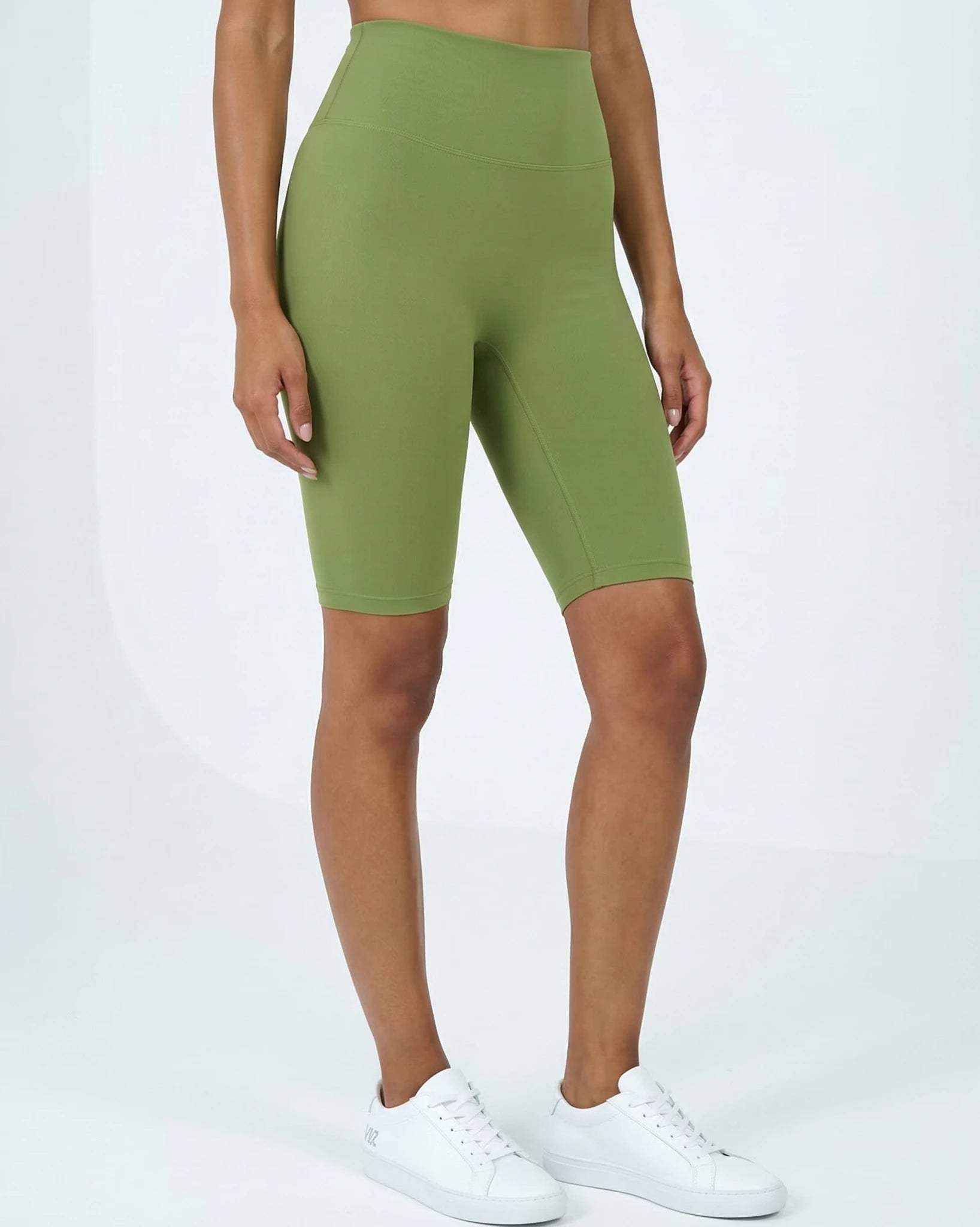 Green athletic shorts worn by a person on a white background