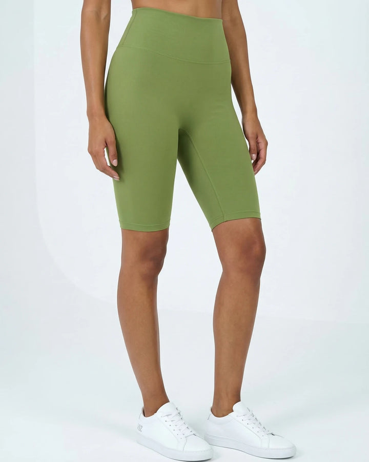 Green athletic shorts worn by a person on a white background