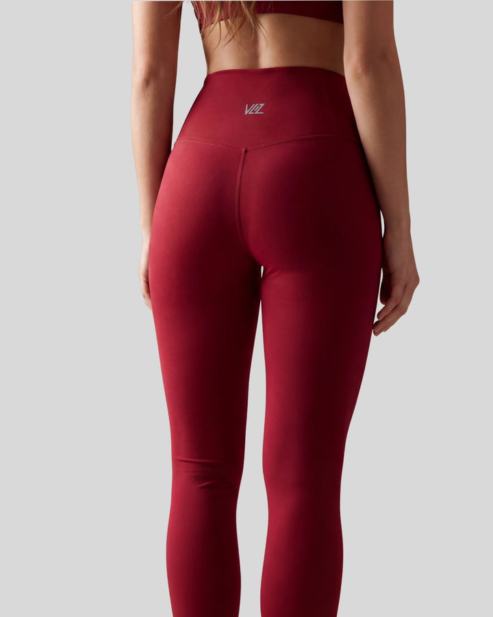 Red leggings with a brand logo on a gray background