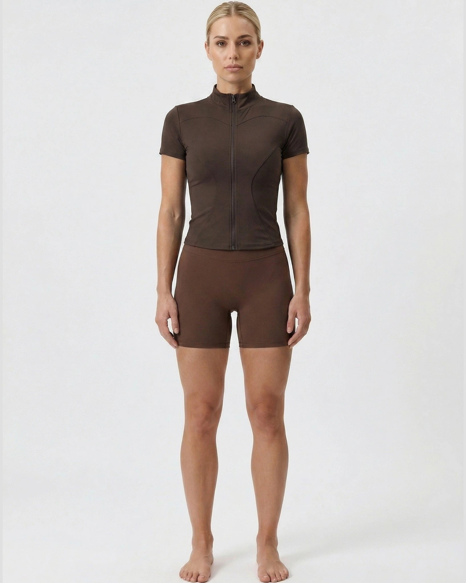 Person wearing a brown athletic outfit on a white background