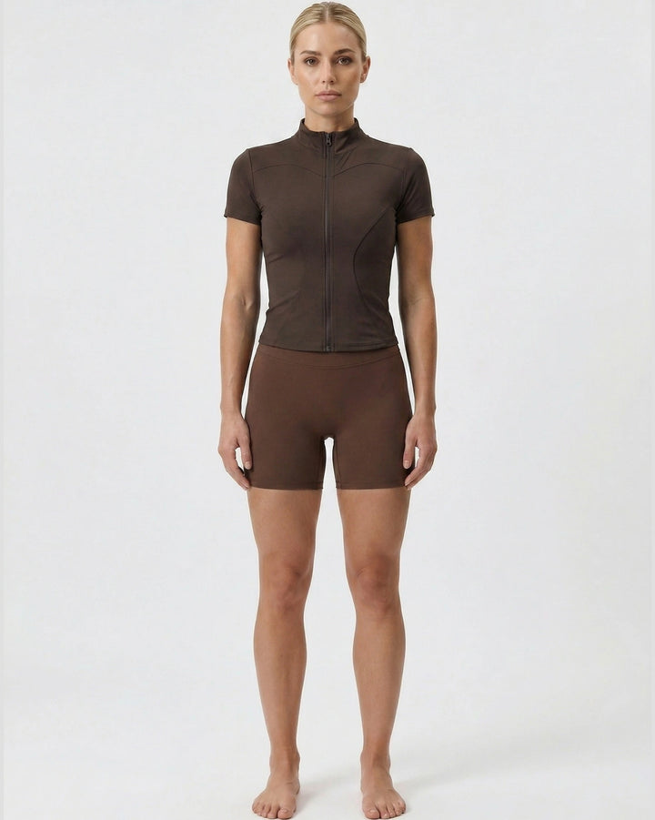 Person wearing a brown athletic outfit on a white background