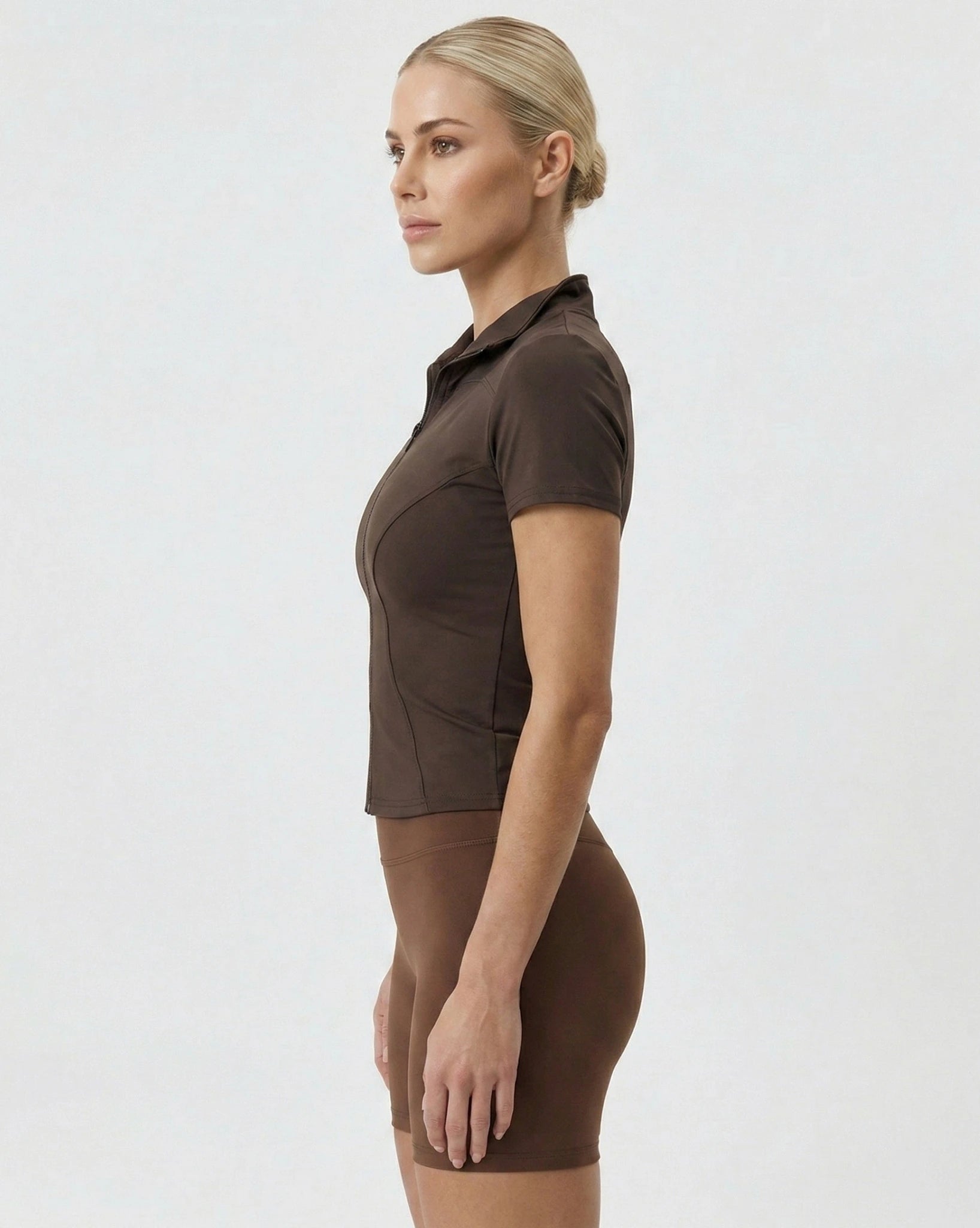 Woman wearing a brown dress against a white background