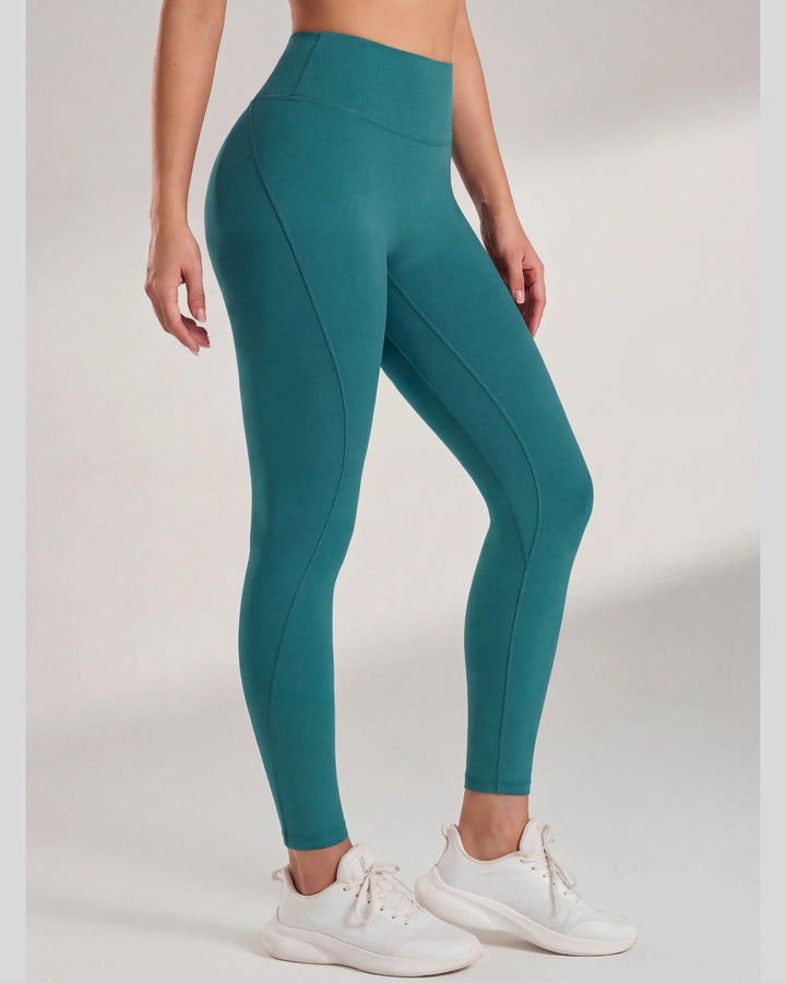 Teal leggings worn by a person on a plain background