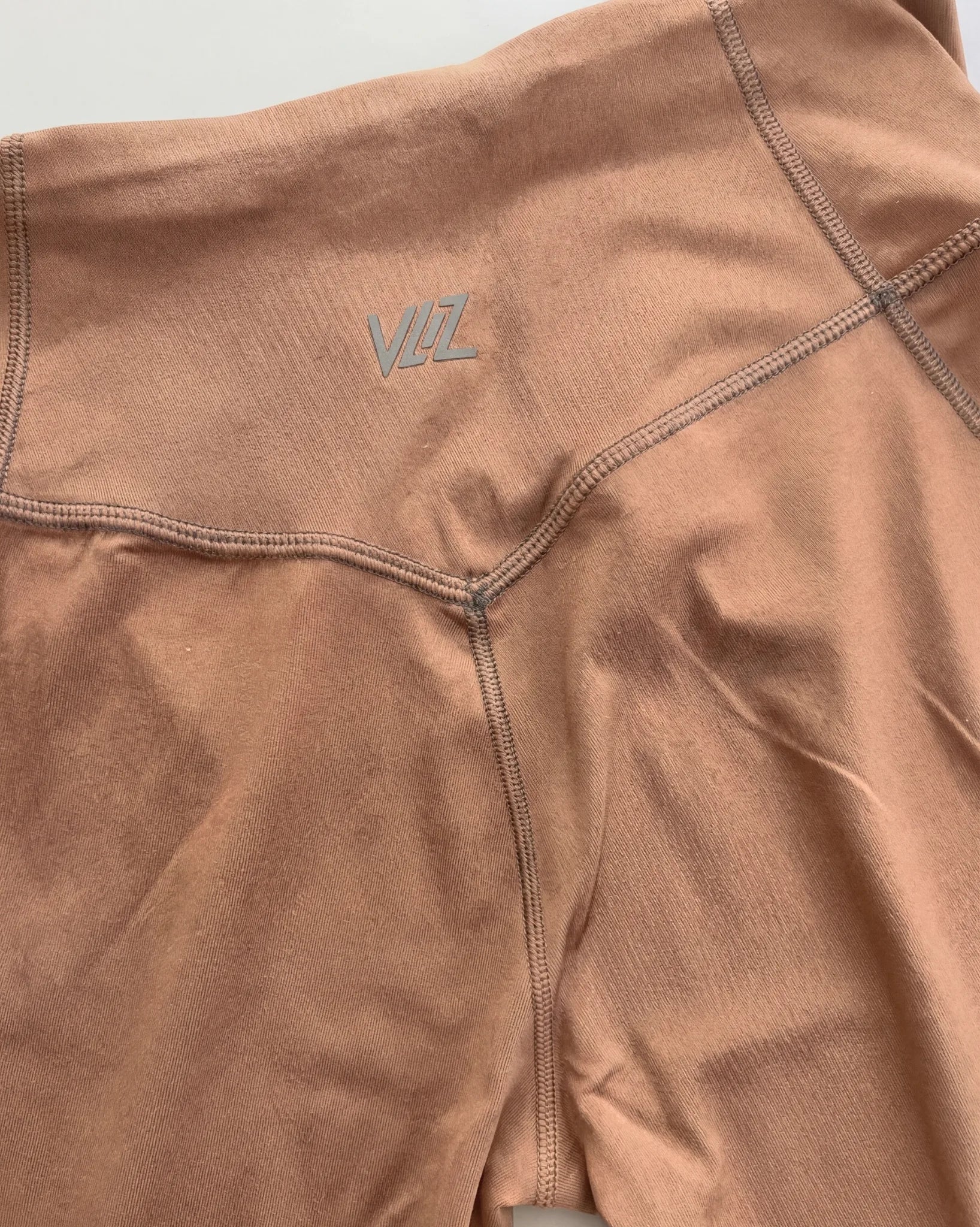 Brown fabric with a logo on a light gray background
