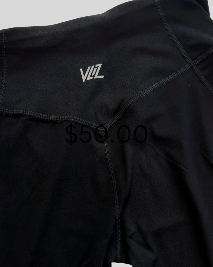 Black athletic outfit with a brand logo and price tag on a light gray background