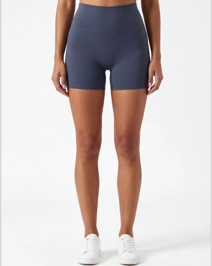 Person wearing navy blue athletic shorts on a white background