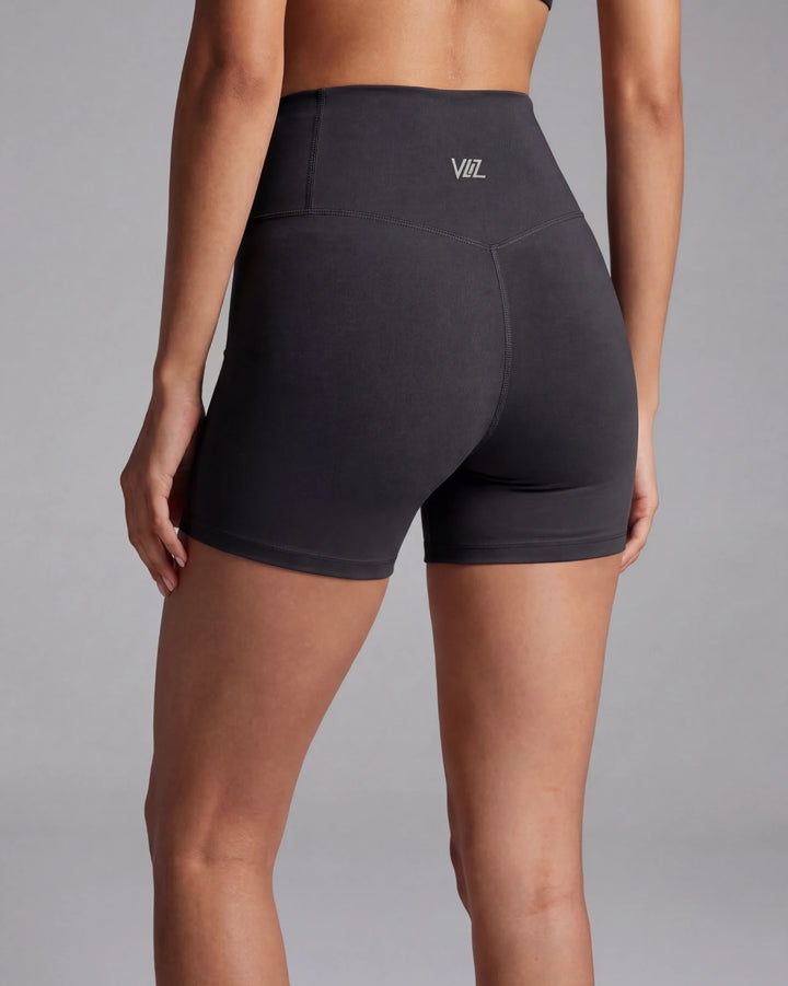 Black athletic shorts with a brand logo on a gray background