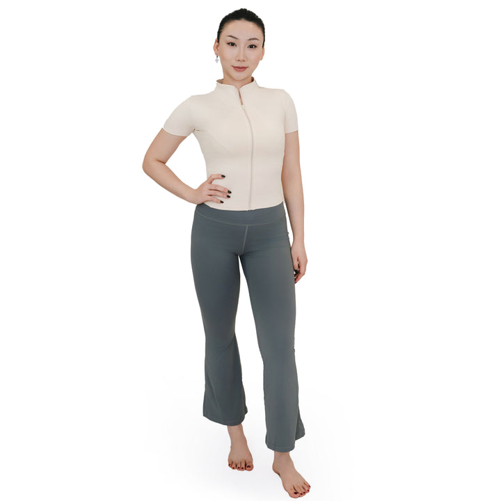 Model wearing VLIZ High-Rise Sculpting Flare Leggings in gray, shown in full-body front view paired with a short-sleeve zip-up top.