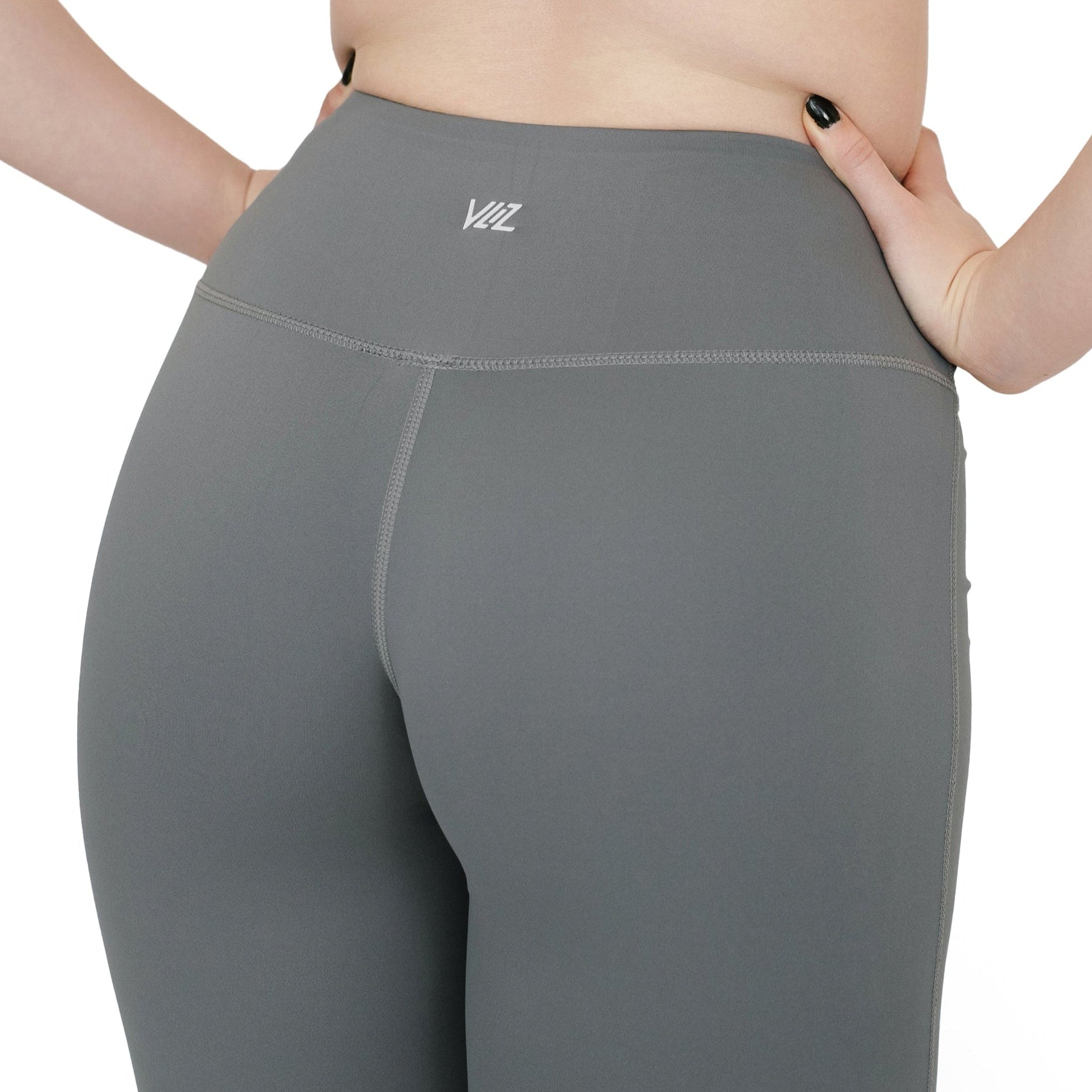 Close-up of back waistband on VLIZ High-Rise Sculpting Flare Leggings in gray, showcasing logo and seam details.