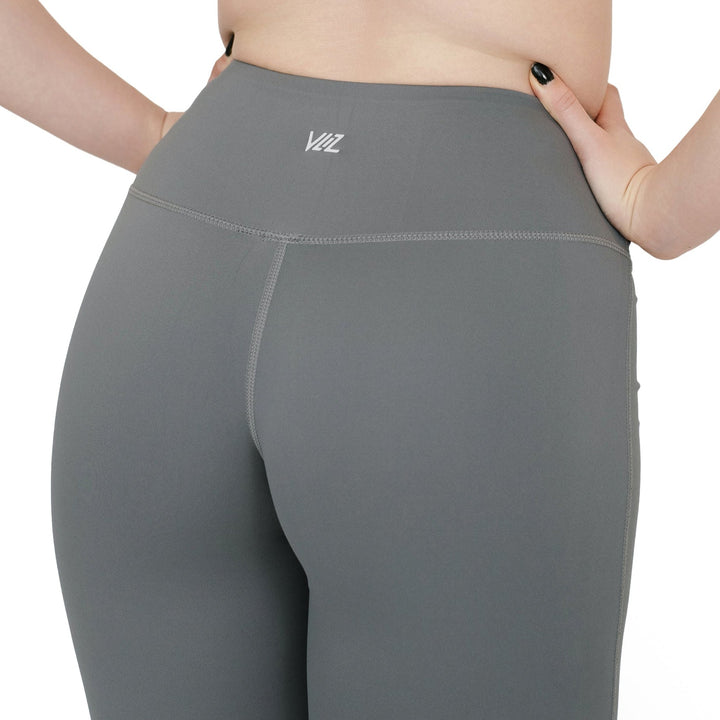 Close-up of back waistband on VLIZ High-Rise Sculpting Flare Leggings in gray, showcasing logo and seam details.