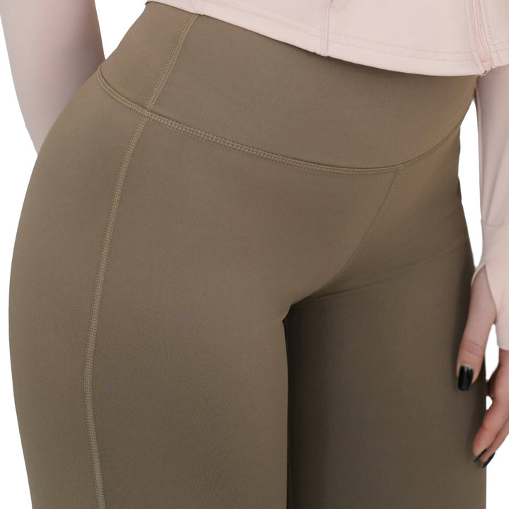 VLIZ High-Rise Sculpting Flare Leggings in light brown shown from front angle, highlighting contoured seam and high waistband design.