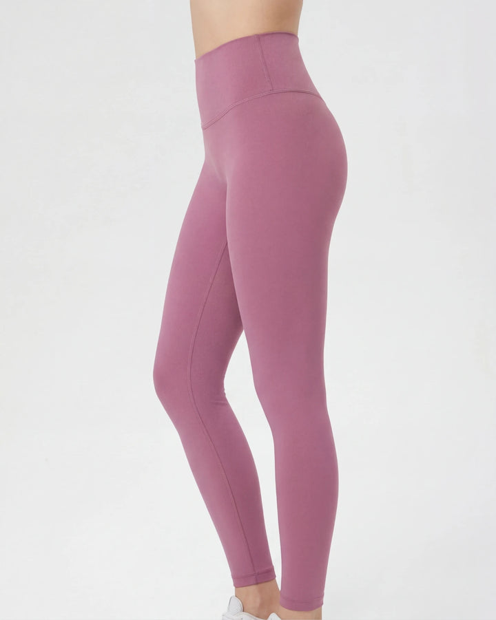 Mauve leggings worn by a person on a white background