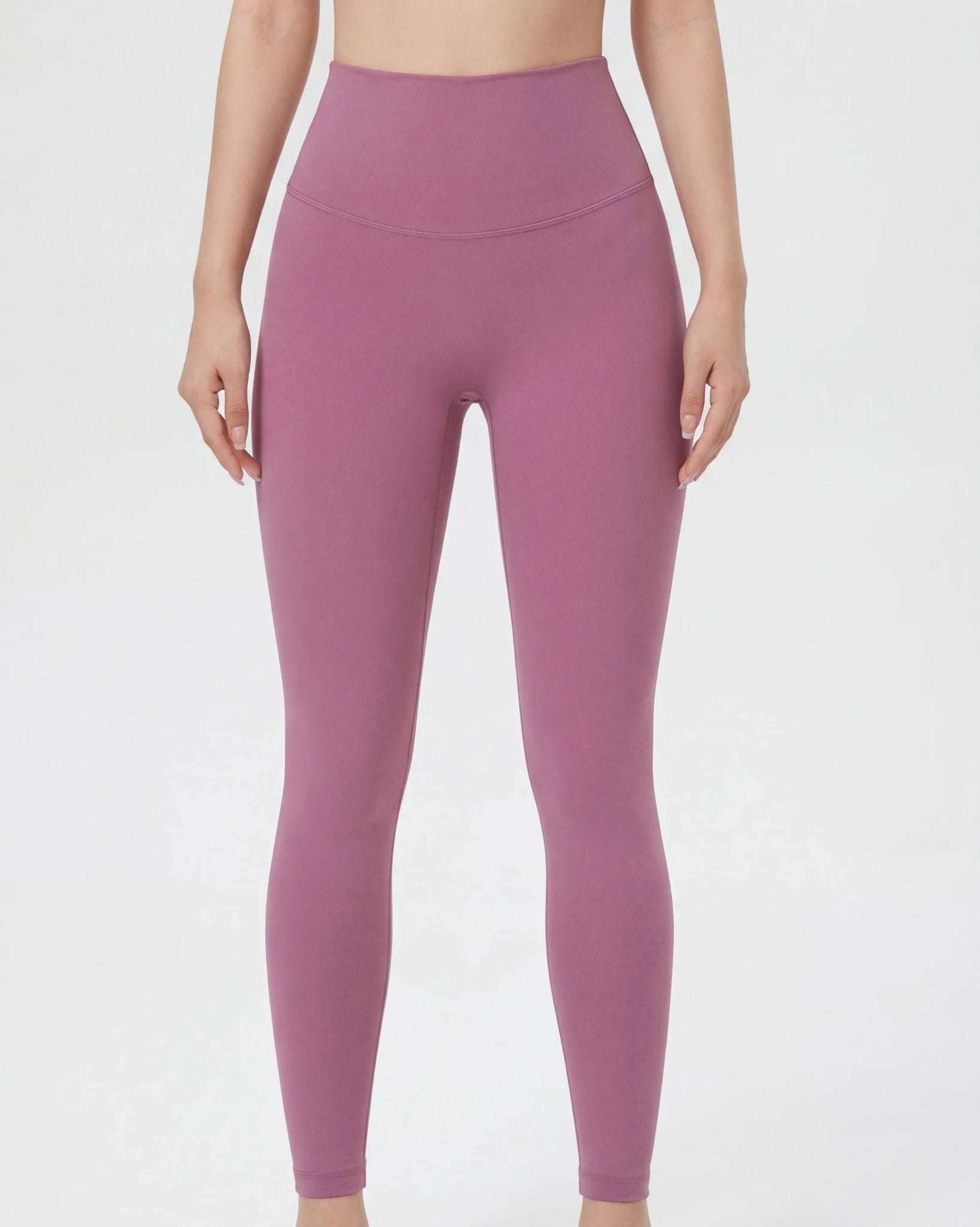Person wearing a pair of pink leggings on a white background