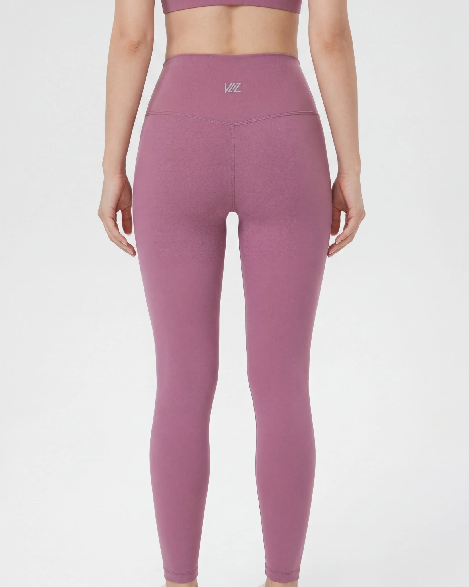 Person wearing pink leggings with a logo on a white background