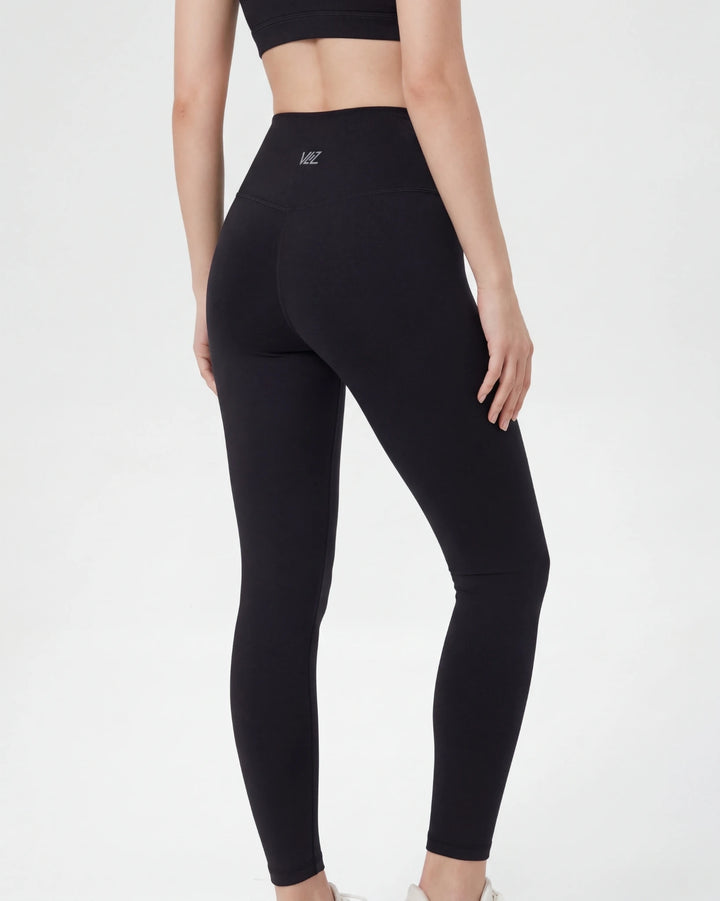 Black leggings worn by a person on a white background