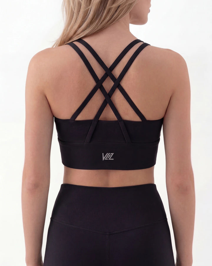 Black sports bra with criss-cross straps on a white background