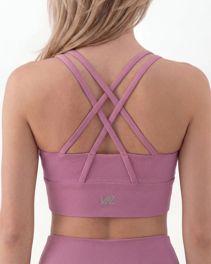 Purple sports bra with criss-cross back design on a white background