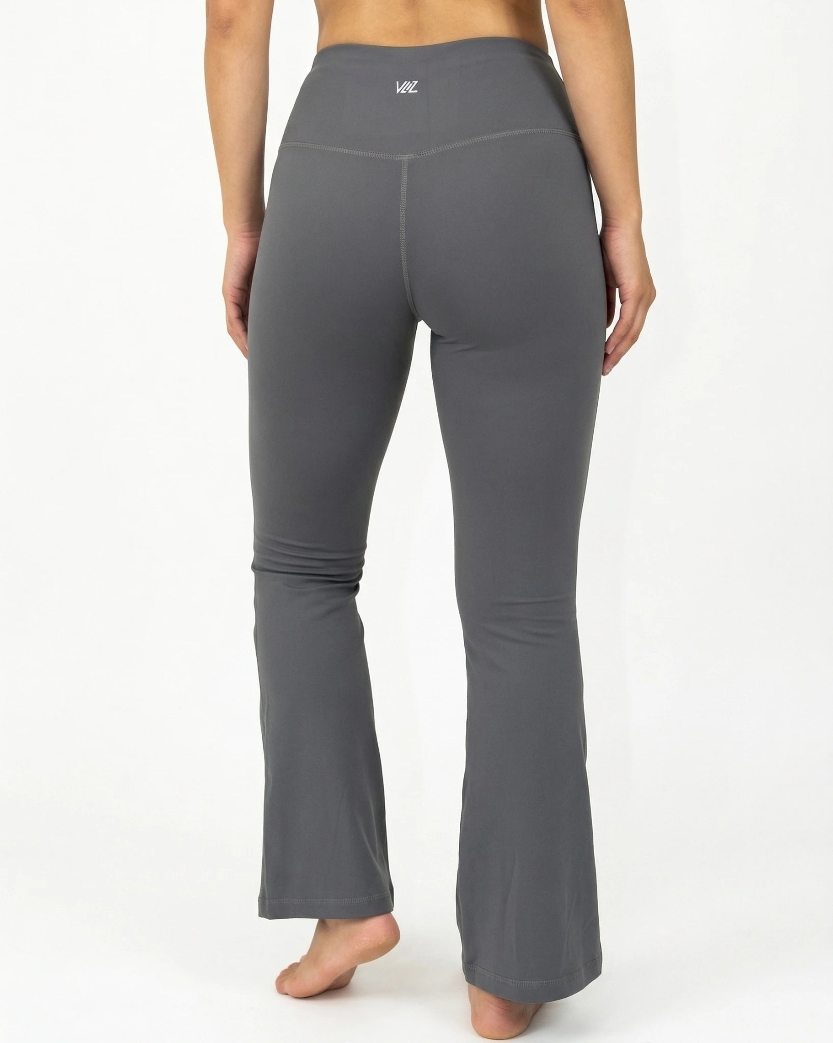 Gray flared leggings worn by a person on a white background