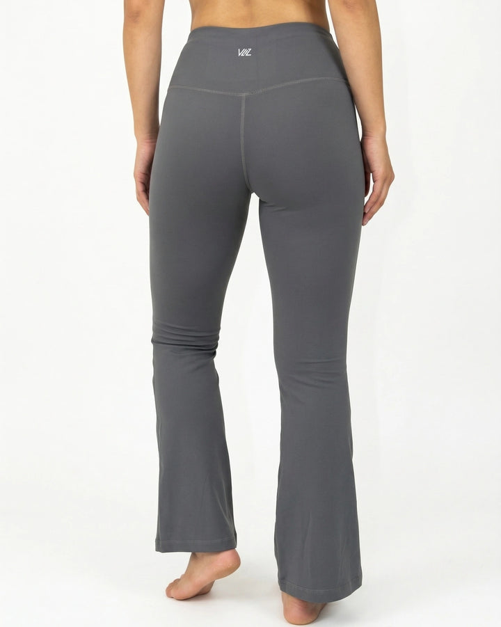 Gray flared leggings worn by a person on a white background