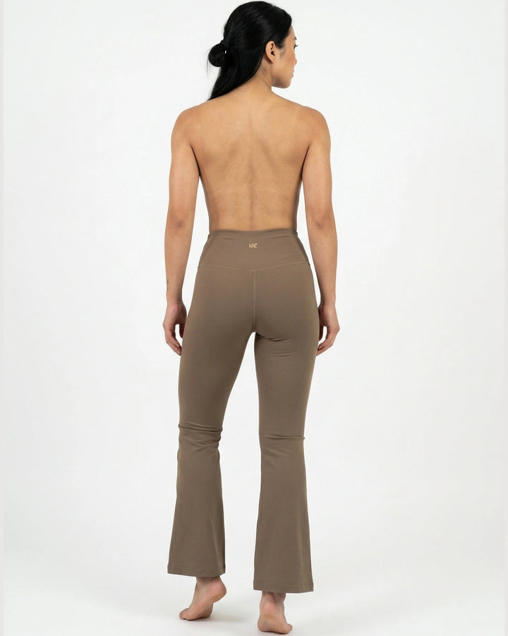 Woman wearing a brown leggings on a white background